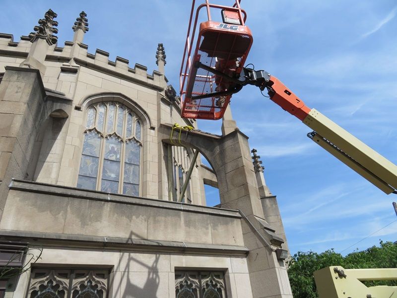 Engineer using lift to repair facade | Facade Repair & Restoration | O'Donnell & Naccarato