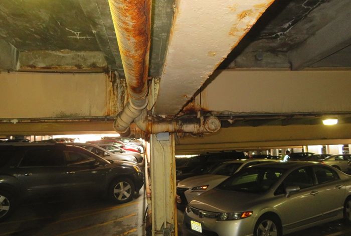 Structural Engineer | Garage Restoration | Newark Beth Israel Garage | Newark, NJ | Close-up of supports and pipe | O’Donnell & Naccarato