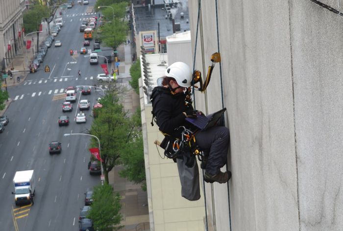 Structural Engineer | Facade Restoration | Temple University | Philadelphia, PA | Aerial shot, worker scaling building | O’Donnell & Naccarato